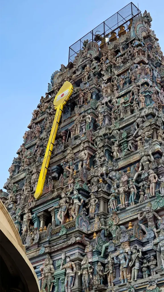 Seven-tiered eastern Rajagopuram of Thiruporur Murugan Temple against blue sky