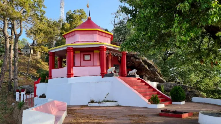 Stone courtyard and sanctum structures of the Kasar Devi Temple complex near Almora.